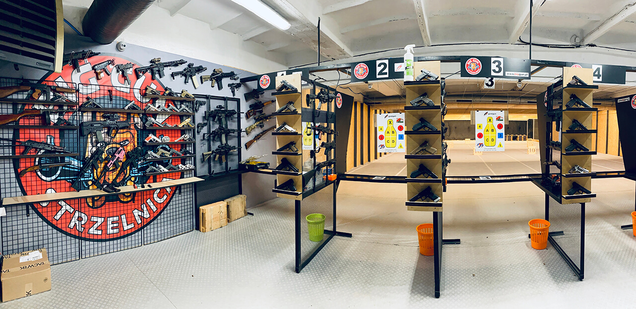 Indoor shooting lanes and firearms display at Big Gun Krakow