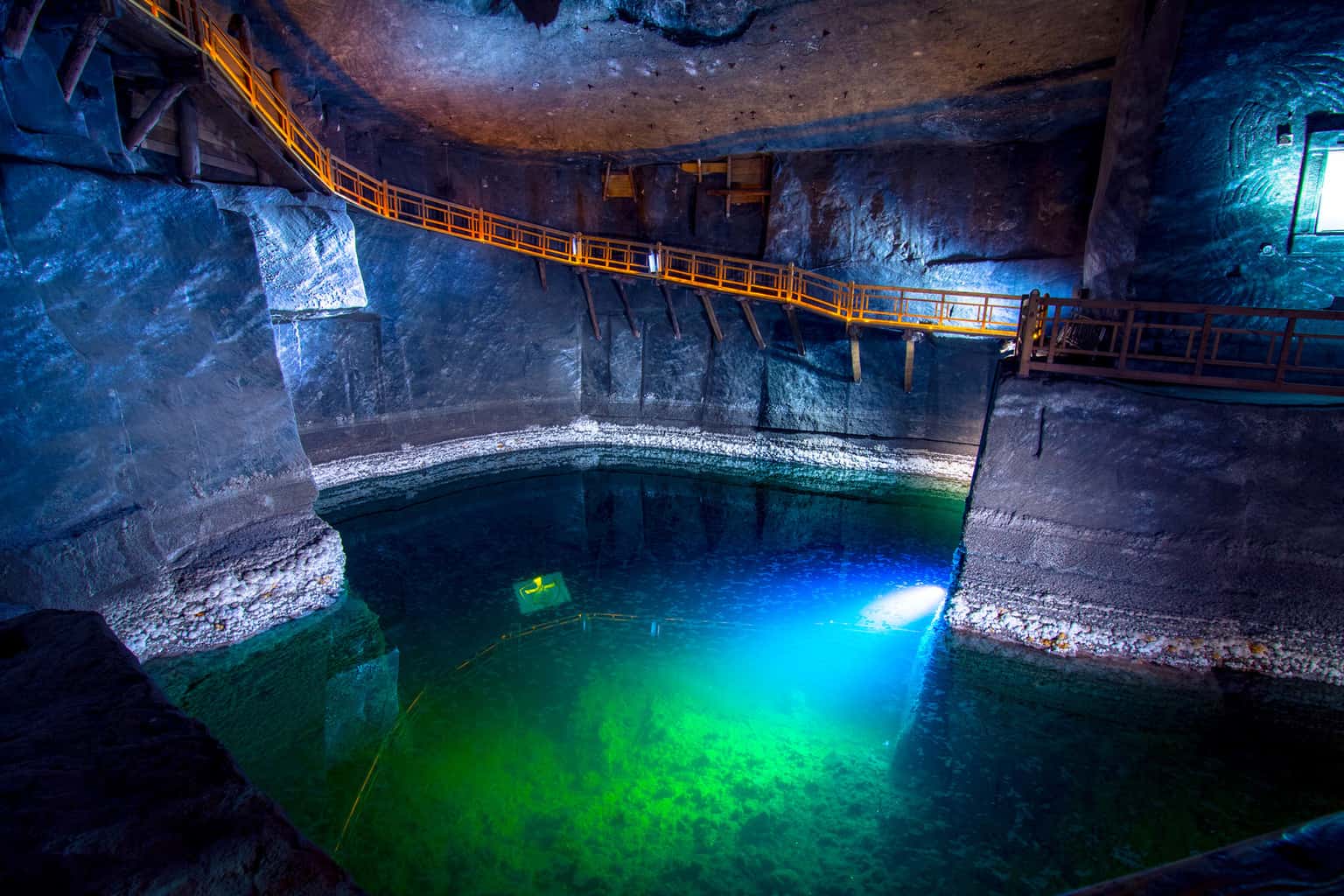 Illuminated underground salt lake with blue lighting – Wieliczka Salt Mine